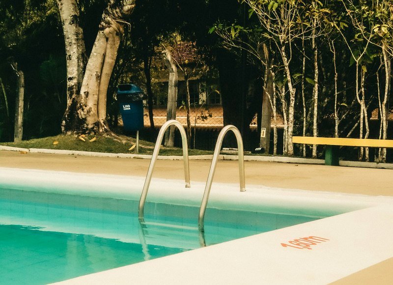 Stainless pool ladder and coping at a clean pool edge
